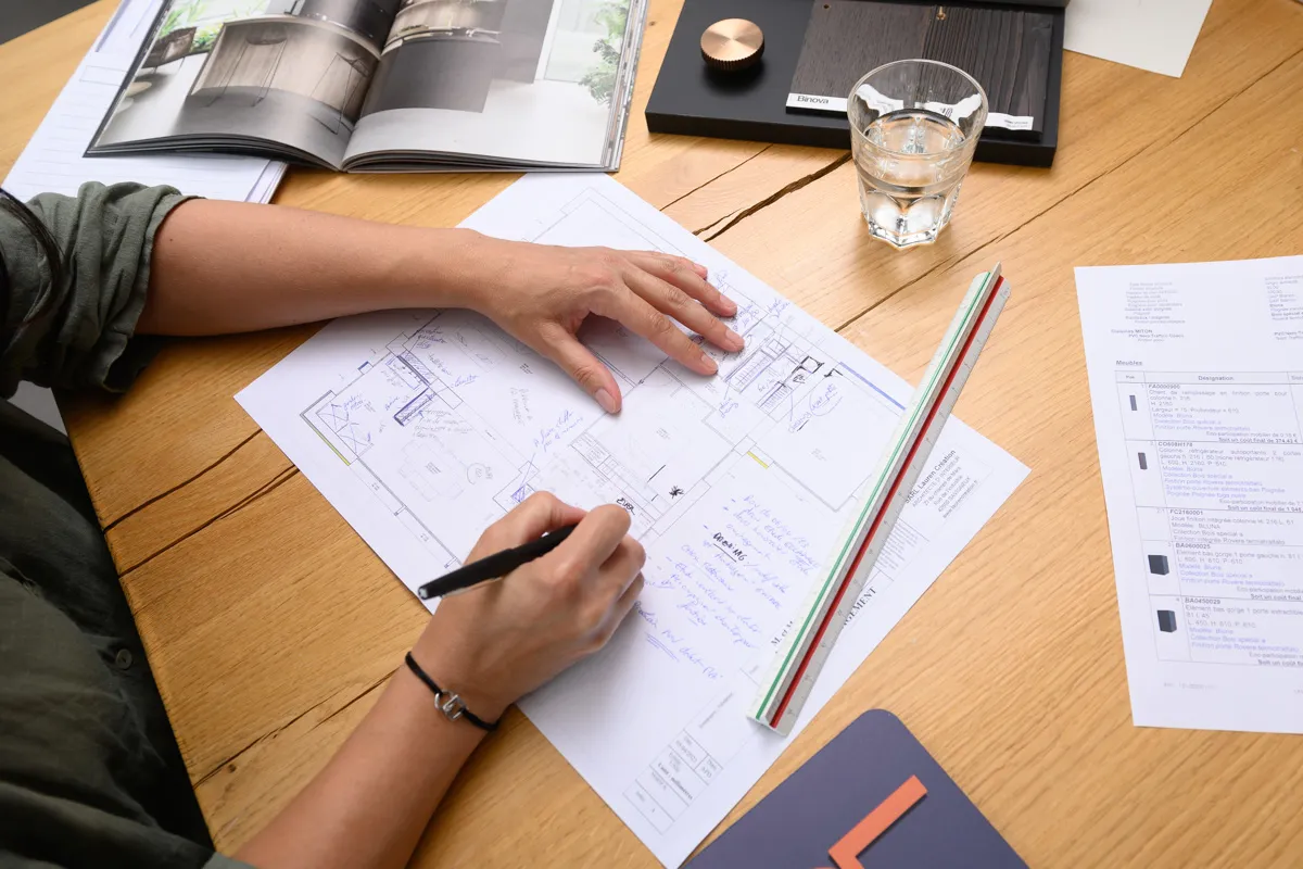 Cuisiniste Cuisines Elite dessinant le plan d'implantation d'une cuisine sur mesure Cuisiniste Cuisines Elite dessinant le plan d'implantation d'une cuisine sur mesure